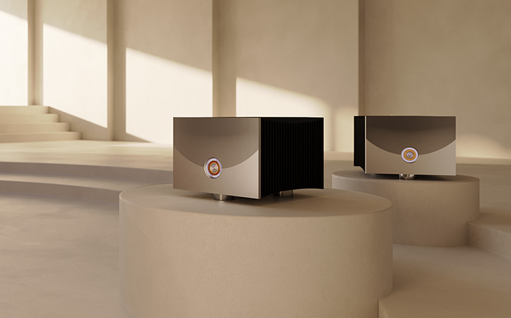A pair of Linn Klimax Solo 800s in silver on podiums in a beige room