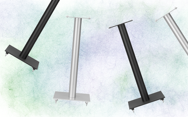 Linn 119 stands.  Two Silver and two black on a splodgy faded green and purple background.