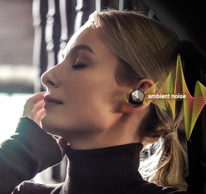 An Astell & Kern AK UW100MKII Earphone bud in the ear of a woman wearing a polo-neck.