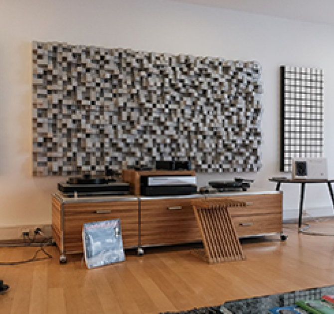 Kii Three BXT System in red in a living room setting with a side unit with two turntables.