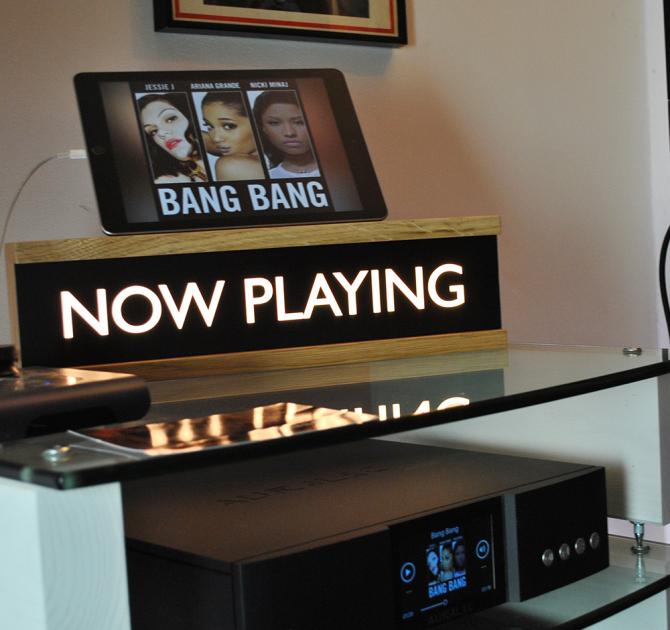 Now Playing wooden lightbox with an iPad propped on top of it