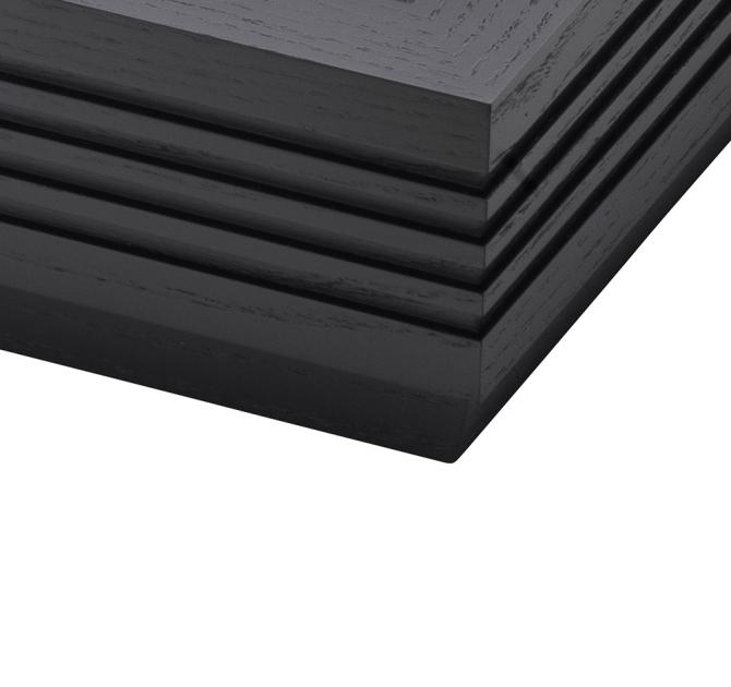 The corner of a fluted black ash plinth