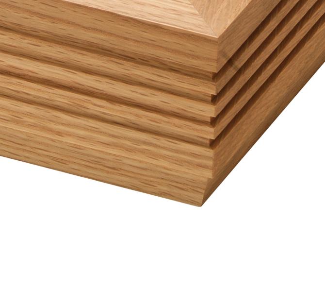 The corner of a Linn LP12 Fluted Plinth turntable in Oak