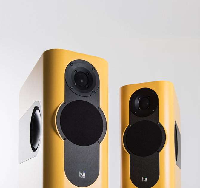 A pair of Kii Three Loudspeakers in matt yellow