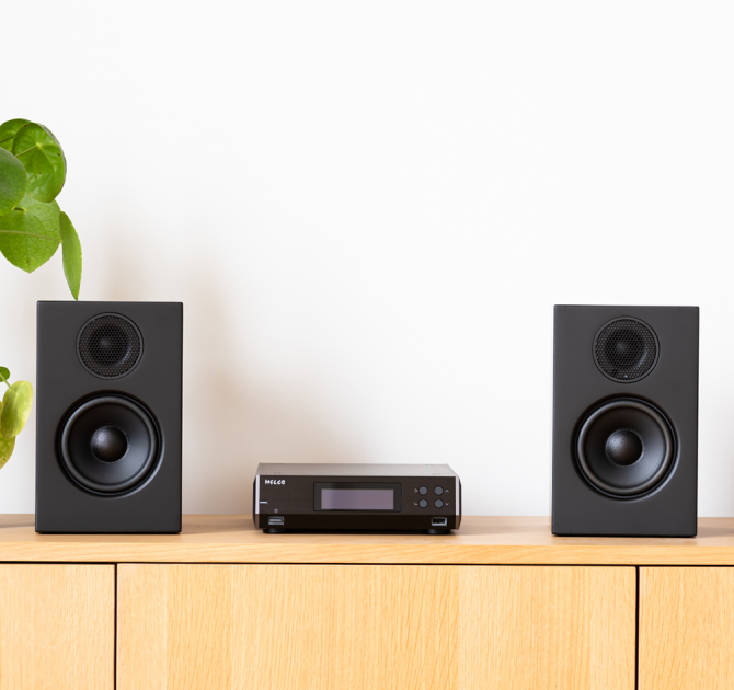 Melco N100 - HiRes Music Library - 5TB HDD, Black between two speakers