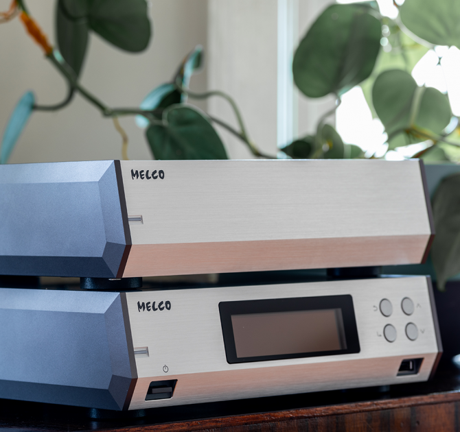 Melco N10/2 Digital Music Library in silver on a table.  One on top of the other.  There's a trailing plant behind.