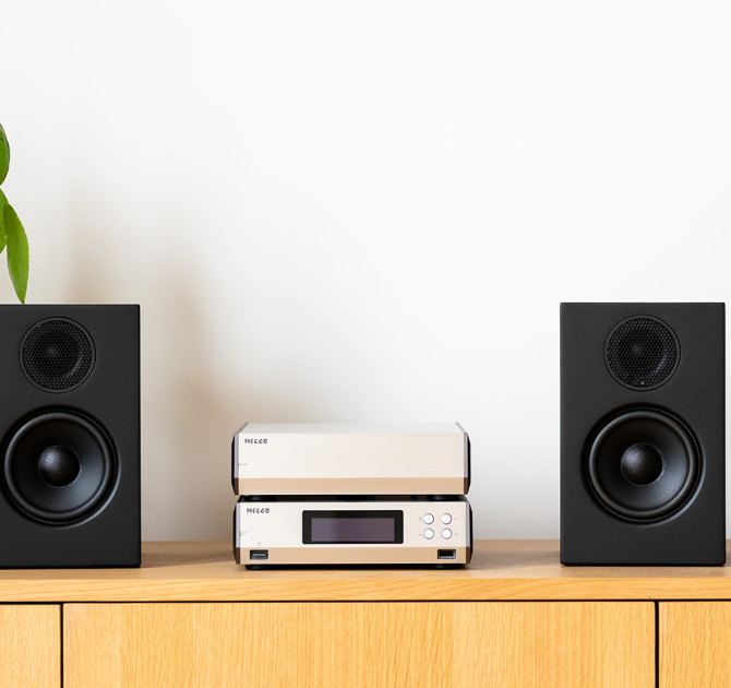 Melco N10/2 Digital Music Library in silver.  One on top of the other on a sideboard between two small, black speakers.