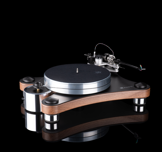 VPI Prime 21 Plus Turntable in walnut standing on a reflective surface.  the background is black.