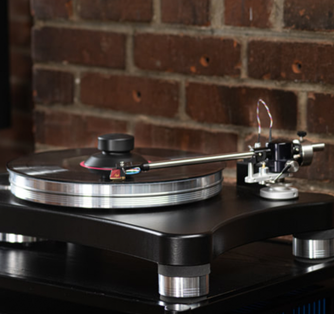 VPI Scout 21 Turntable in action with a brick wall behind.