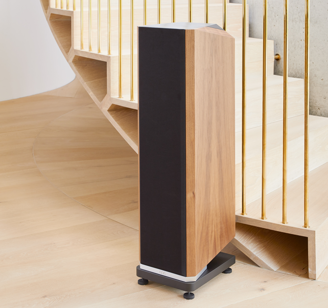 Kudos Titan 606 speaker with grill on at the side of a staircase.
