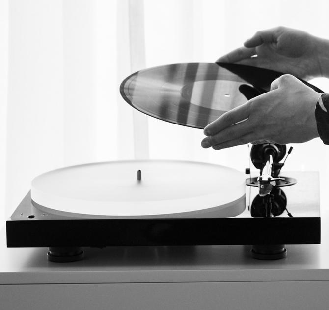 Project X1 B Turntable hands putting a record on