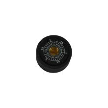 A black cylinder that's wider than it is tall with a hole in the centre and numbered markings around the edge.