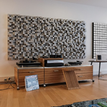 Kii Three BXT System in red in a living room setting with a side unit with two turntables.