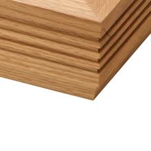 The corner of a Linn LP12 Fluted Plinth turntable in Oak