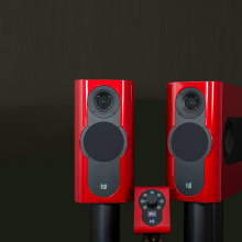 A pair of Kii Three Loudspeakers in gloss red with matching Kii Controller