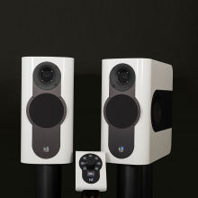 A pair of Kii Three Loudspeakers in gloss white with matching Kii Controller
