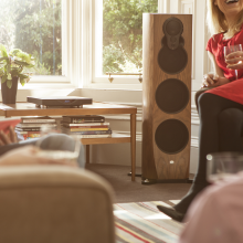 Linn Klimax DSM in black on a coffee table in front of a window, next to a Linn 350 speaker.