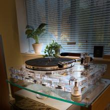 Vertere MG-1 MKII Magic Groove Turntable in the ripcaster showroom.  it's in front of a blind and there's a plant on the windowsill.