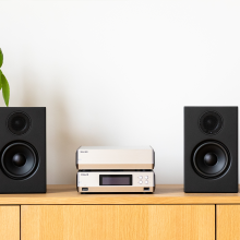 Melco N10/2 Digital Music Library in silver.  One on top of the other on a sideboard between two small, black speakers.