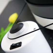 Project RPM 5 Carbon - Turntable in white with a close-up of the on/off switch and the belt.