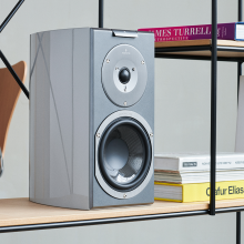 Audiovector R1 Signature in custom grey on a shelf beside some books