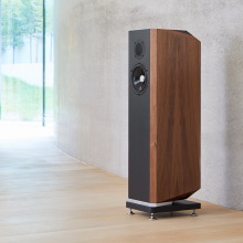 Kudos Titan 606 Speakers in front of a polished concrete wall.