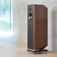 A single Kudos Titan 707 speaker with the grill off in front of a polished concrete wall.