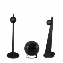 A pair of Cabasse iO3 Loudspeakers in black on a black stand with a Cabasse Pearl Sub in black between them